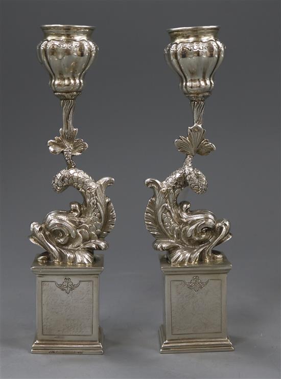 A pair of Italian 800 white metal dolphin candlesticks, on pedestal bases, 23.5 oz.